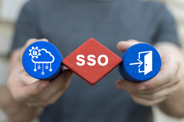 Man holding colorful blocks sees text: SSO. Single Sign-On ( SSO ) concept. Authentication...