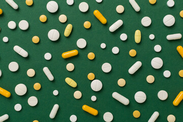 Flat lay with different medical pills and capsules on color background