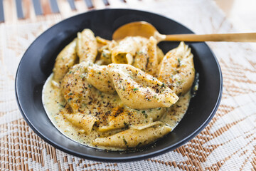 plant-based creamy shell pasta with herbs and dairy-free sauce