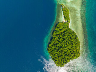 Tropical island landscape with sandbar beach and turquoise and deep blue sea. Millari Island. Mindanao, Philippines.