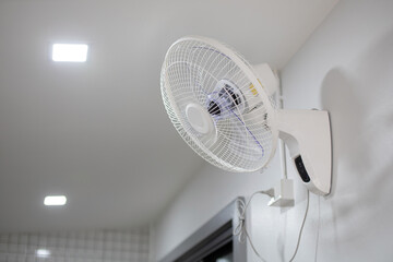 White wall fan installed inside the home or office.