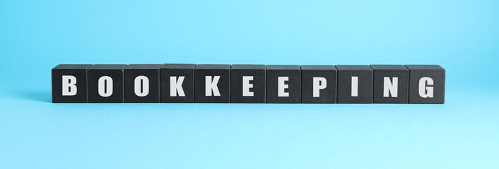 Word Bookkeeping made with black cubes on light blue background