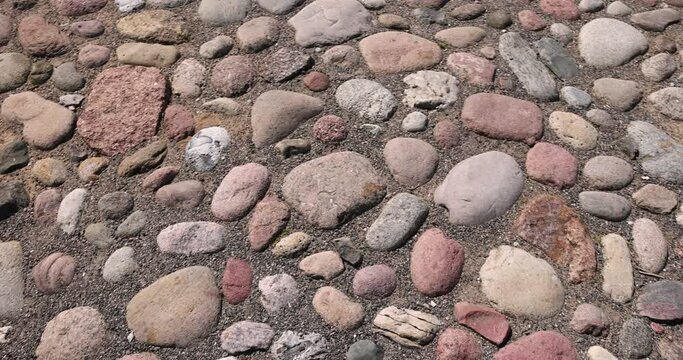 a road made of stones and cobblestones, details of a highway made of stones and cobblestones