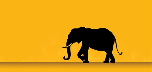 Asian elephant silhouette on solid yellow background with copy space.