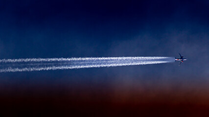 Airplane flying in the blue sky with white clouds in the background