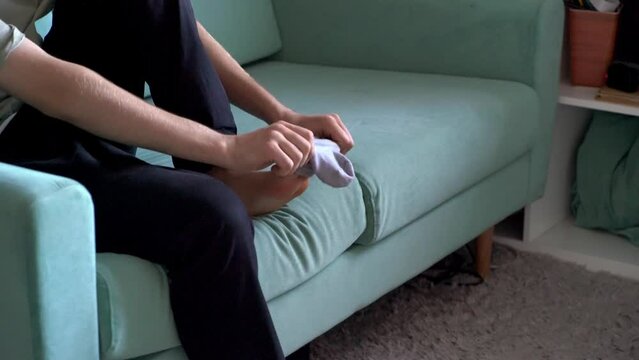 person holding a sock and put it on in the morning