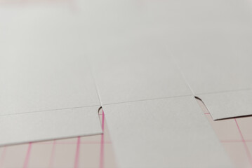 Macro Perspective: Die-cut Paper Templates on a Cutting Mat in a Design Studio