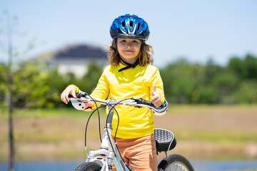 Kid riding bike in a helmet. Child riding bike in protective helmet. Safety kids sports and...