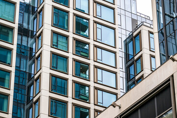 Contemporary multi-story building made of concrete and glass with strict geometric shapes and...