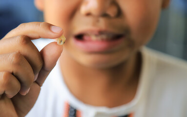 kid holding tooth decay from eating too much sweet food in daily life, healthy and health care...