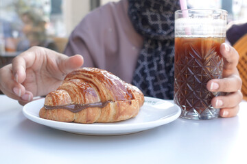 cream and chocolate on croissant 