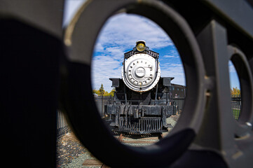 Unusual perspective through wrought iron fencing of Union Pacific Locomotive No.2252, one of the...