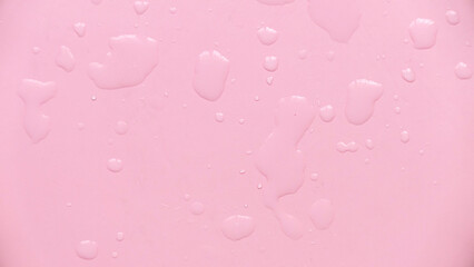 Water drops over a pink background for creative poster design.