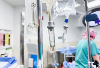 intravenous drug drip hangs, symbolizing medical care, treatment, and the monitoring of a patient's...