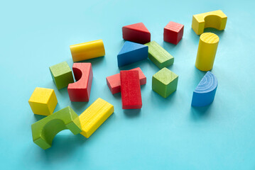 Educational toys, Cognitive skills, kid development. Colorful Montessori geometric shapes toys over a blue background.