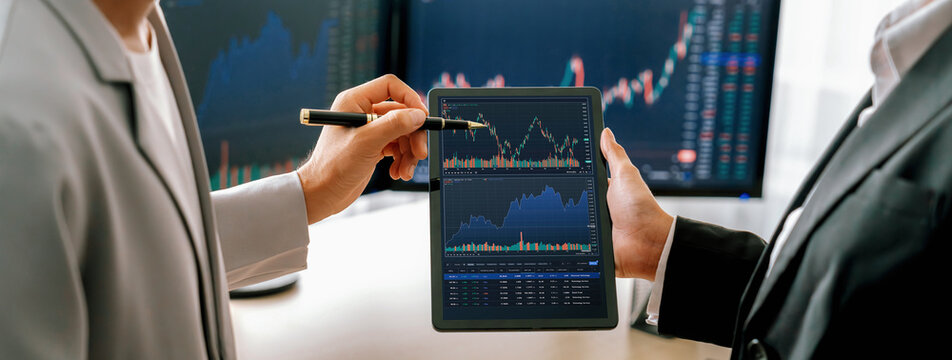 Cropped image of professional broker show tablet displayed growth graph in skilled trader at stock market. Stock investment. Stock trading. Stock market trading concept. Burgeoning.