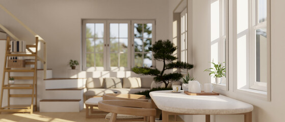 Fototapeta na wymiar A minimal dining table against the window in a beautiful cosy Scandinavian living room.