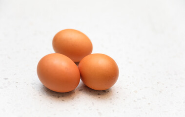 brown eggs in a rustic basket on wooden table, natural light, farm-fresh concept