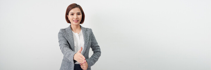 Young Asian business woman in gray suit reaching for shake hand to greet someone, Panorama