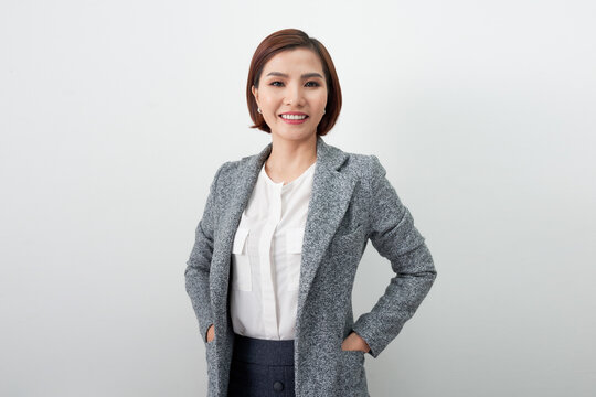 Young asian woman, professional entrepreneur standing in office clothing, smiling.