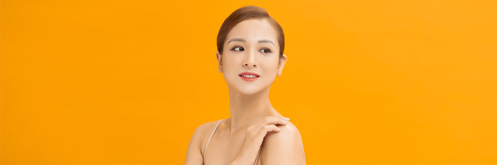 Banner of beauty smiling asian woman applying a lotion to her arm skin during her dressing up