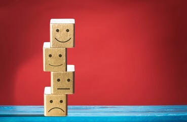 Satisfaction survey. Wooden cube with face symbol.