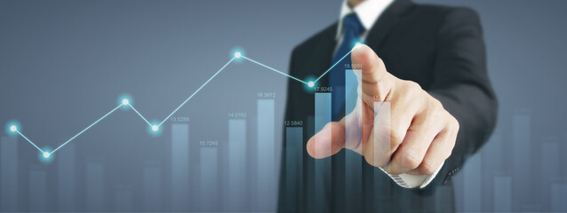 Businessman with chart financial symbols coming from hand