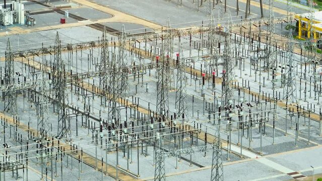 in the heart of the city, the high voltage power station looms ominously, a symbol of raw energy coursing through cables like lightning in the night. Drone view.
