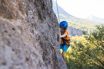 climber boy. the child trains in rock climbing.