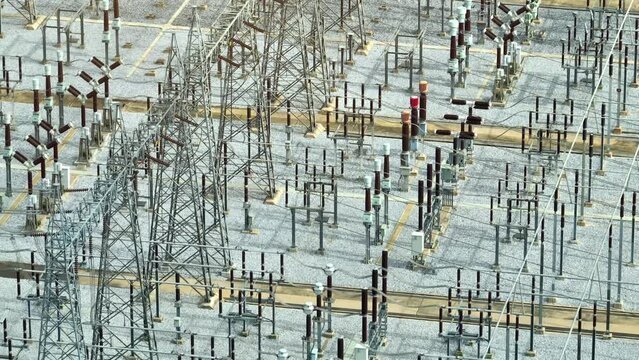 Captured from above, the high voltage power station is a testament to human engineering, a sprawling network of steel and cables, where energy surges through the veins of the grid.
