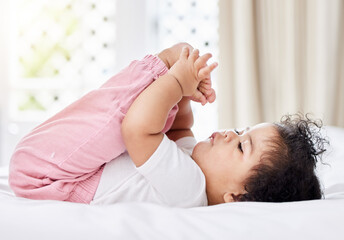 Baby, feet and hands with curiosity in bedroom for motor skills, growth or development. Little...