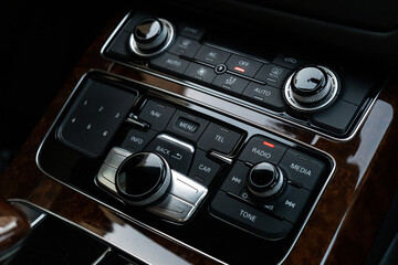 Interior of modern luxury car. Details of automatic transmission gear shift, multimedia control...