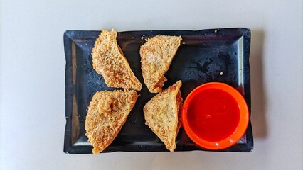 Tahu walik is a tofu-based snack that contains meatballs. With tomato sauce white background.
