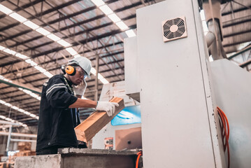 Woodworkers operate machines, tend lathes to cut, shape wood fixtures in manufacturing process