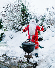 Santa Claus in the snowy forest with a barbecue. Christmas and New Year.