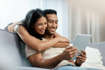 Happy, love and couple hug with tablet on sofa for social media, movies or streaming film at home....