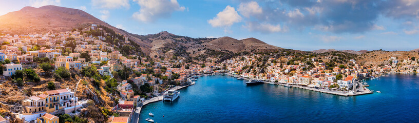 Aerial view of the beautiful greek island of Symi (Simi) with colourful houses and small boats. Greece, Symi island, view of the town of Symi (near Rhodes), Dodecanese. - 684937759