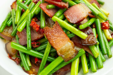 A plate of fried bacon with garlic and moss