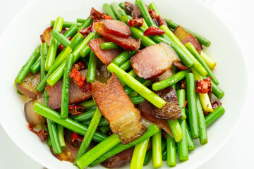 A plate of fried bacon with garlic and moss