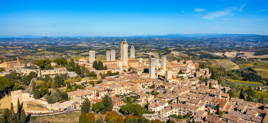 Fototapeta na wymiar Town of San Gimignano, Tuscany, Italy with its famous medieval towers. Aerial view of the medieval village of San Gimignano, a Unesco World Heritage Site. Italy, Tuscany, Val d'Elsa.