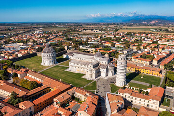 Fototapeta na wymiar Pisa Cathedral and the Leaning Tower in a sunny day in Pisa, Italy. Pisa Cathedral with Leaning Tower of Pisa on Piazza dei Miracoli in Pisa, Tuscany, Italy.