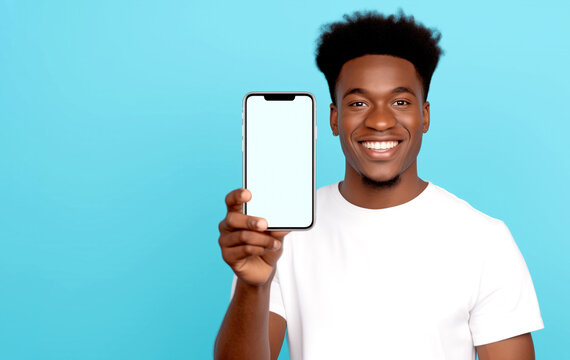 SMILING AFRICAN AMERICAN MAN HOLDING SMARTPHONE WITH WHITE SCREEN. legal AI