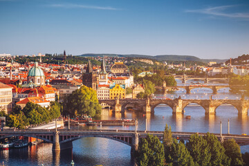 Fototapeta na wymiar Prague View of the Vltava River and the bridges shined with the sunset sun, Prague, the Czech Republic