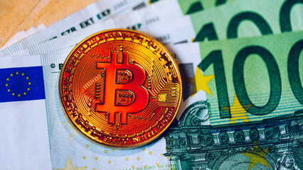 Bitcoin cryptocurrency (crypto currency) over Euro money. Golden Bitcoin symbol. Bitcoin (BTC) cryptocurrency.