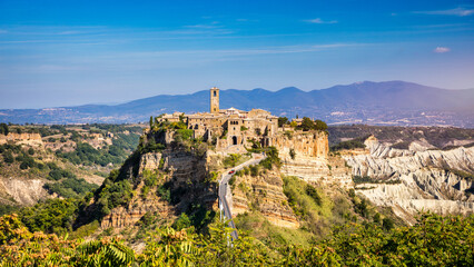 Fototapeta na wymiar The famous Civita di Bagnoregio on a sunny day. Province of Viterbo, Lazio, Italy. Medieval town on the mountain, Civita di Bagnoregio, popular touristic stop at Tuscany, Italy.
