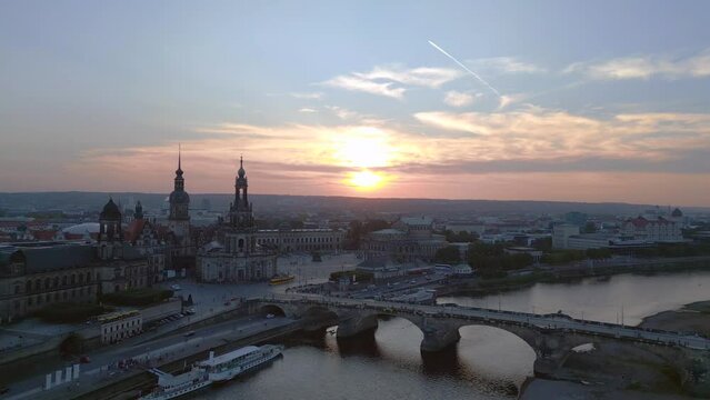 Dramatic aerial top view flight 
Sunset city Dresden Church Cathedral Bridge River. pull in drone
4k Landscape footage