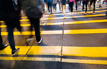 Busy people on zebra crossing street in Hong Kong
