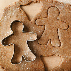 Cooking ginger cookies, Christmas and New Year traditional cookies in shape of gingerbread man, raw...