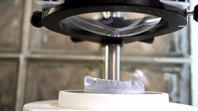 Mouth guard for teeth, printed on a 3D printer in dental clinic laboratory. 4k cinematic slow motion video