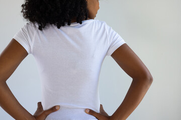 Rear view of biracial woman in white t-shirt with copy space on white background - Powered by Adobe